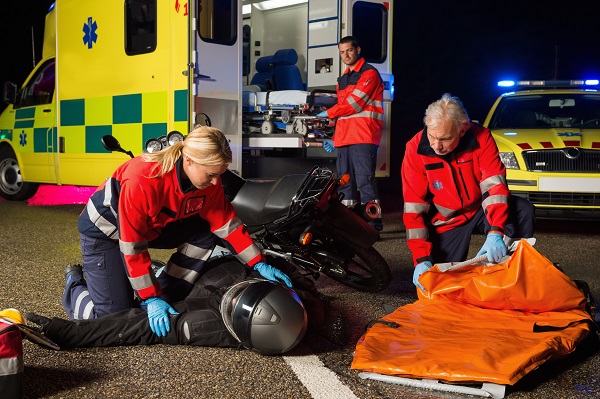 Emergency team assisting injured rider following a motorcycle accident in Georgia.