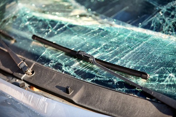 Close up of the shattered windscreen and wipers of a car that has been involved in an accident