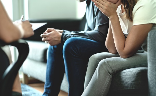 Hopeless and upset man and woman in therapy.