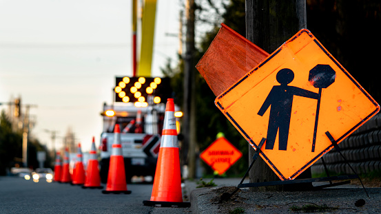 Lane closure on a busy road due to road work signs