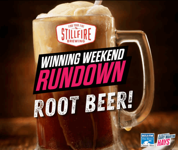 Promotional image of a frosty mug of root beer with foam, featuring logos for StillFire Brewing, 97.1 FM The River, and The Law Offices of Gary Martin Hays & Associates, with bold text reading “Winning Weekend Rundown Root Beer!”