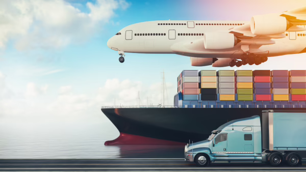 A blue semi-truck traveling on a highway alongside a massive container ship and a low-flying cargo airplane, illustrating global shipping networks and logistics chain complexities relevant to freight broker liability in truck accidents. (