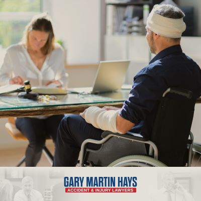 A man with a broken arm and a bandaged head sitting in a wheelchair after an accident in Duluth