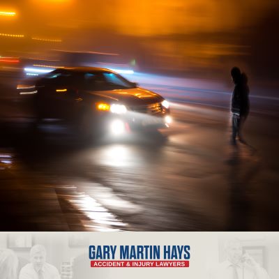 A pedestrian crossing the street at night as a reckless, speeding driver approaches.